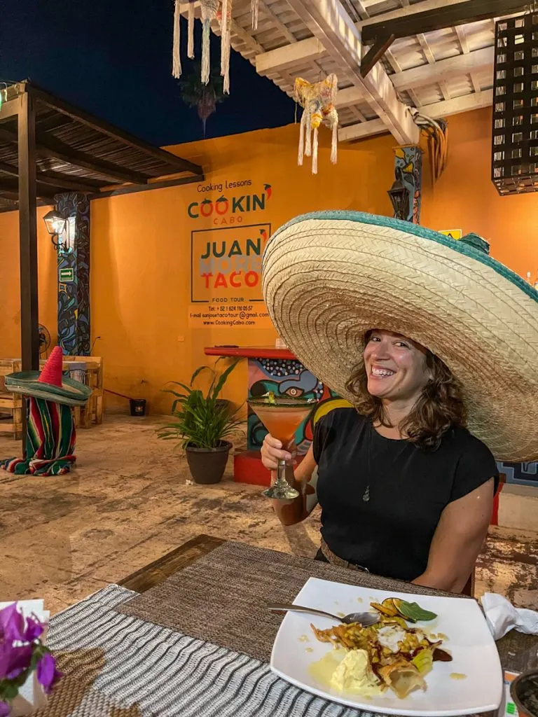 woman with sombrero at a restaurant on vacation in mexico