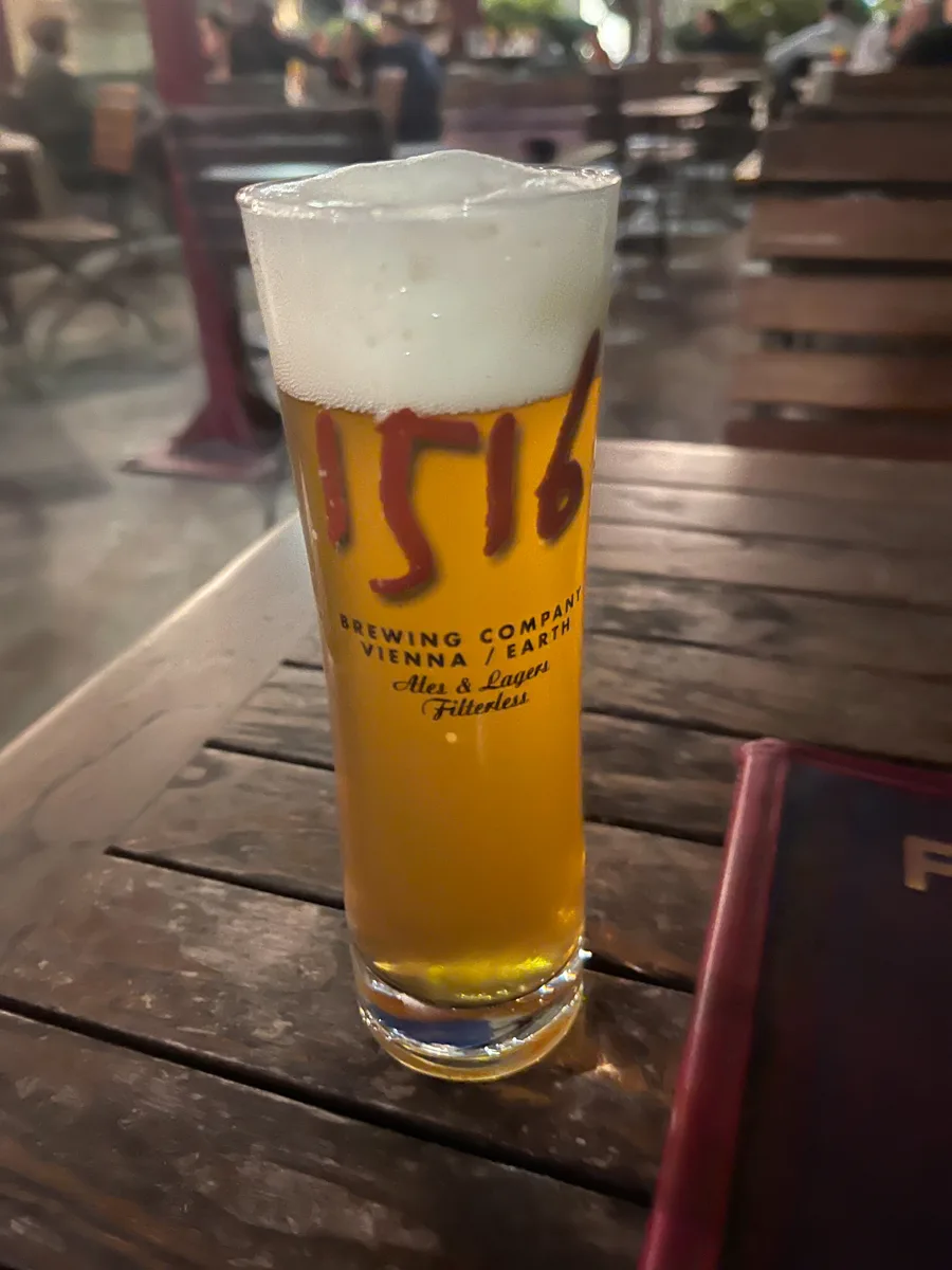 beer with 1516 on the glass on top of a wooden table at the best restaurants in vienna