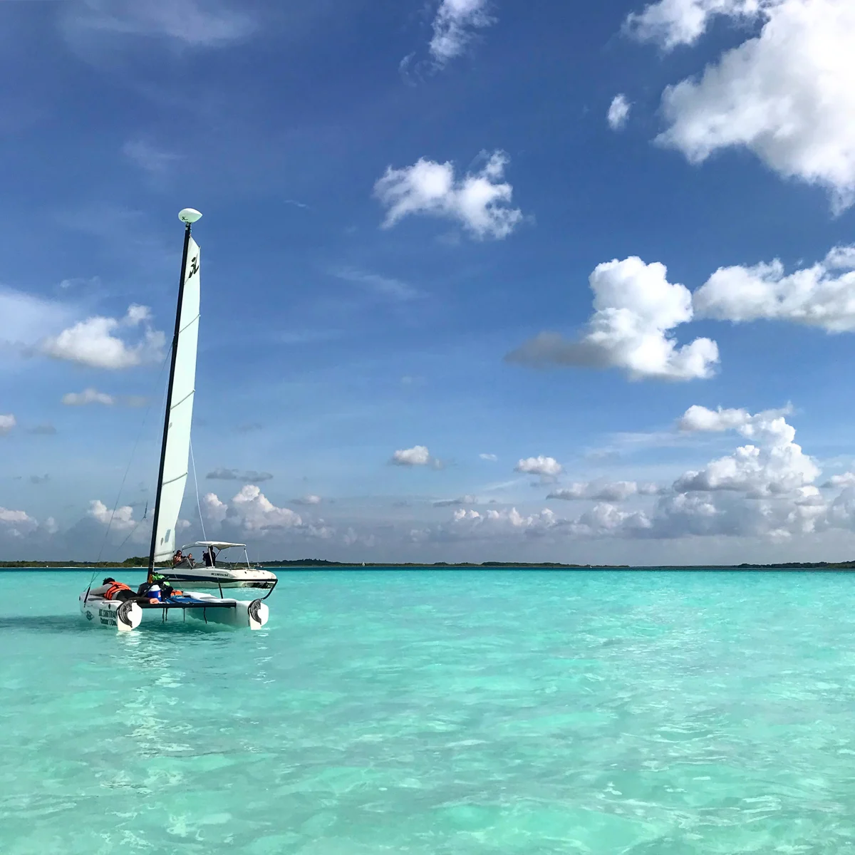 sail boat sitting on crystal clear waters.