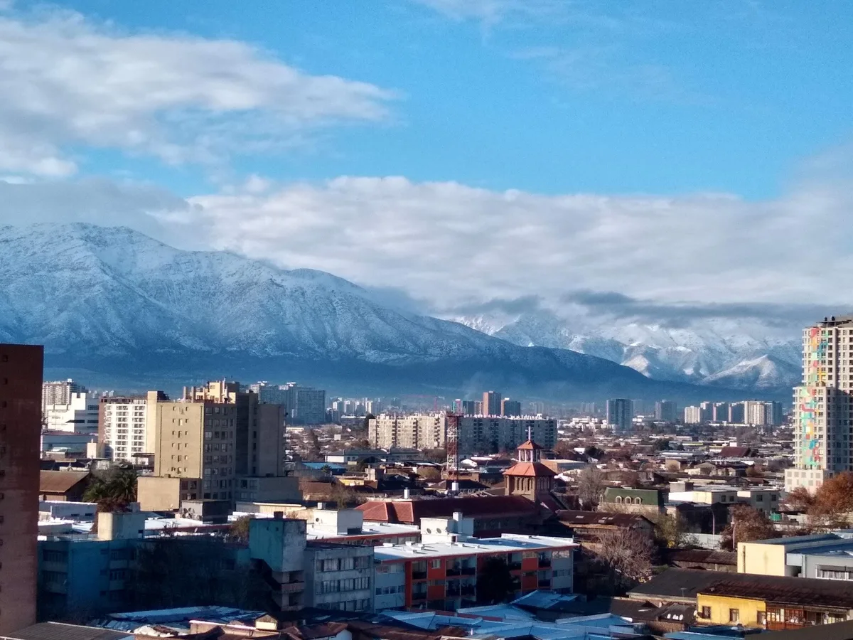 clear skies with mountains and santiago city center in the foreground.