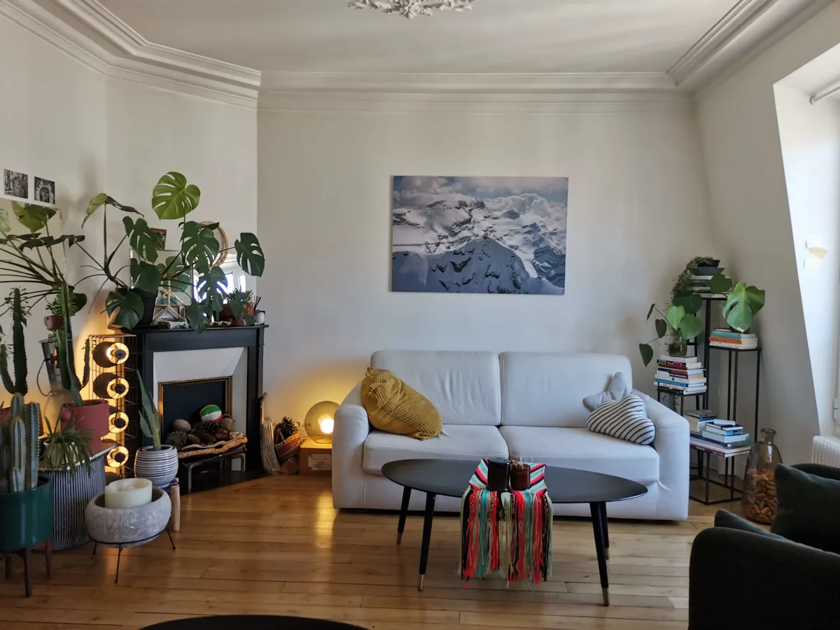 living room with couch and fireplace with a coffee table in front of it.