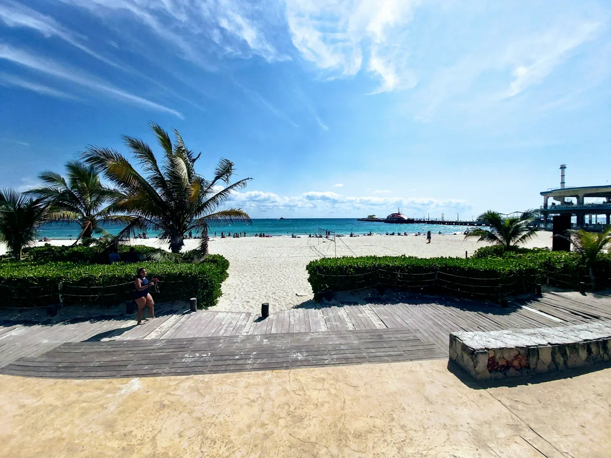 entrance to the beach with blue skies in February which is the best time of year to visit playa del carmen.