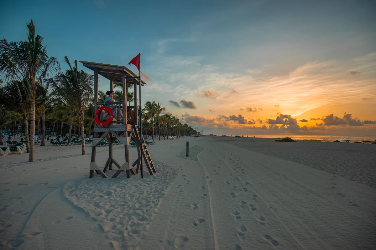 sunset over the beach with lifeguard chair.