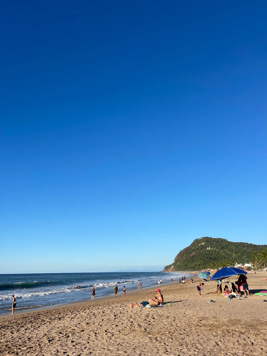 calm beach with hill in the background