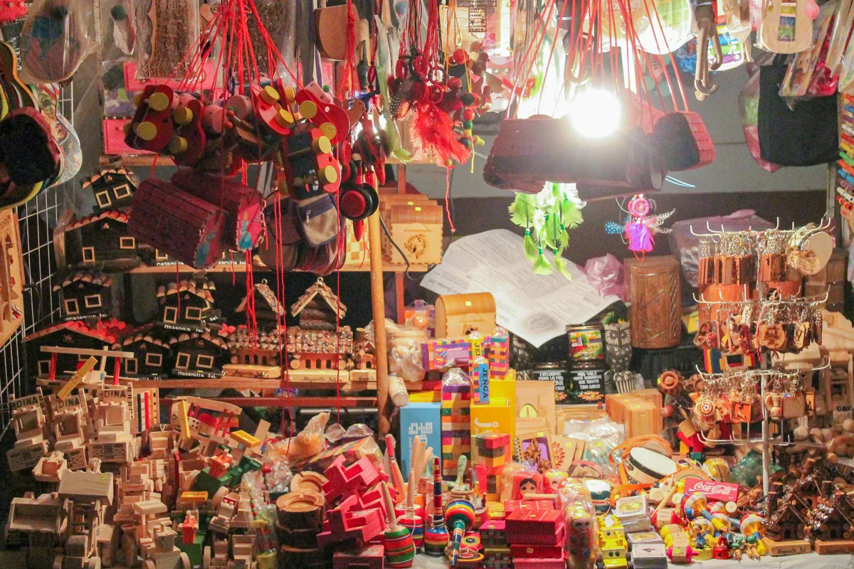 inside of a market with lots of colorful souvenirs to buy.