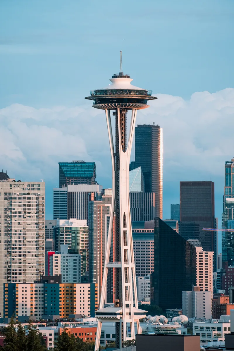 seattle space needle with the city behind it and blue skies.