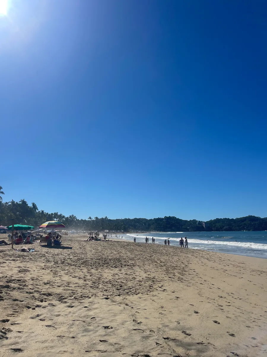 long sandy beach with bright blue skies.