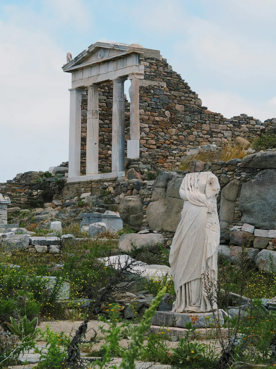 ruins made of marble pilars and sculptures without a head on a naxos to delos day trip.