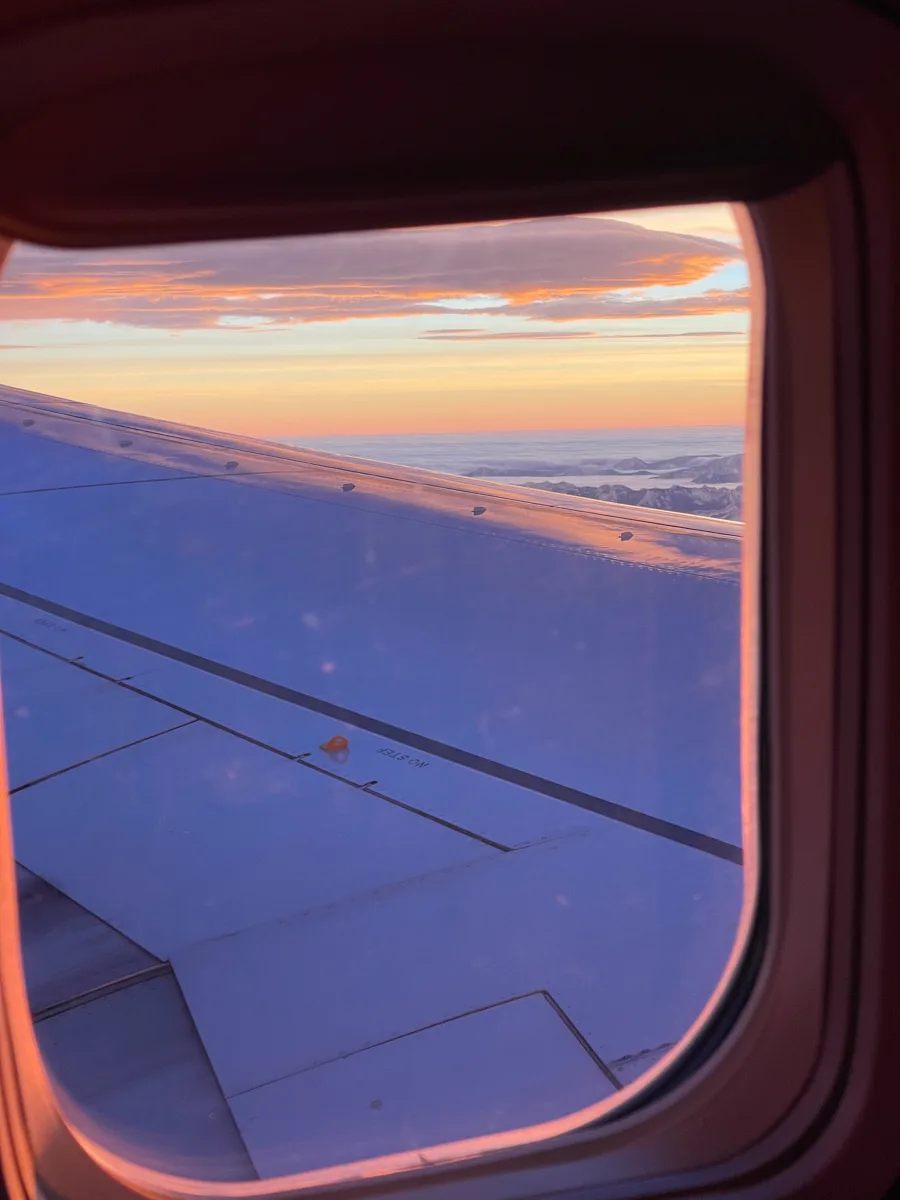 sun setting out of the window from a plane wing as you come into land at Puerto Vallarta Airport.