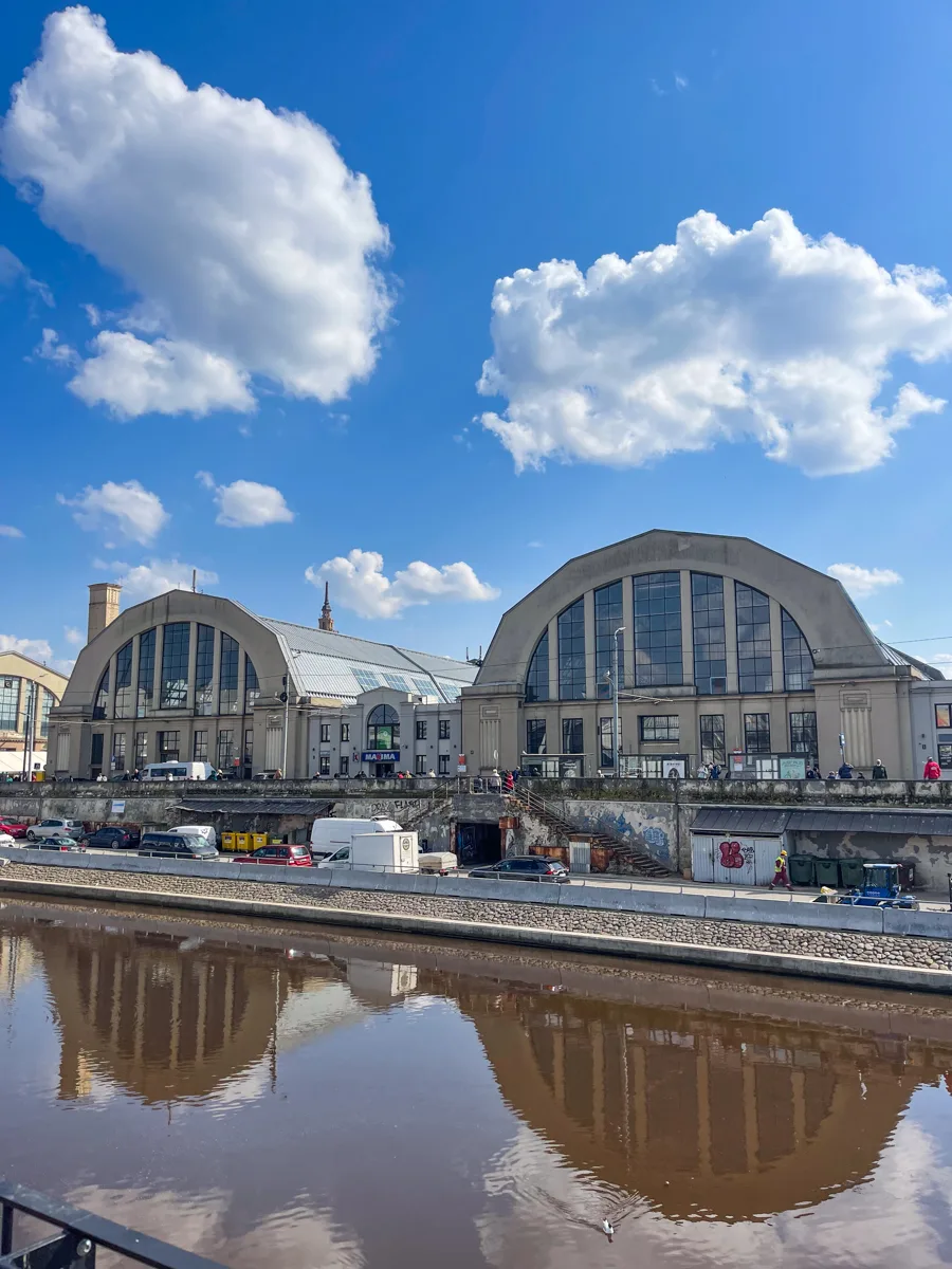 two domes across a river with the reflection in the river in Riga in the baltics.