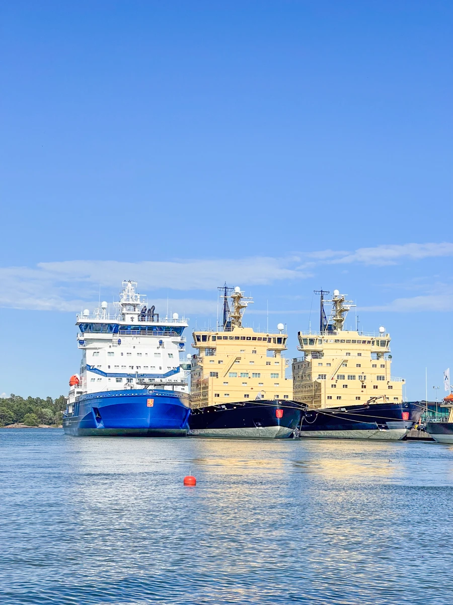 three large ice breaker ships docked in port in Helsinki.