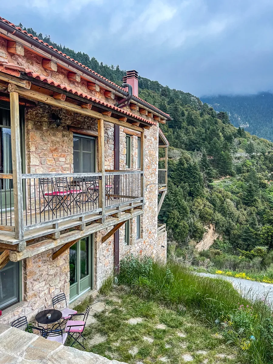 the side angle of a stone building with balconies that face out towards the unseen mountains.