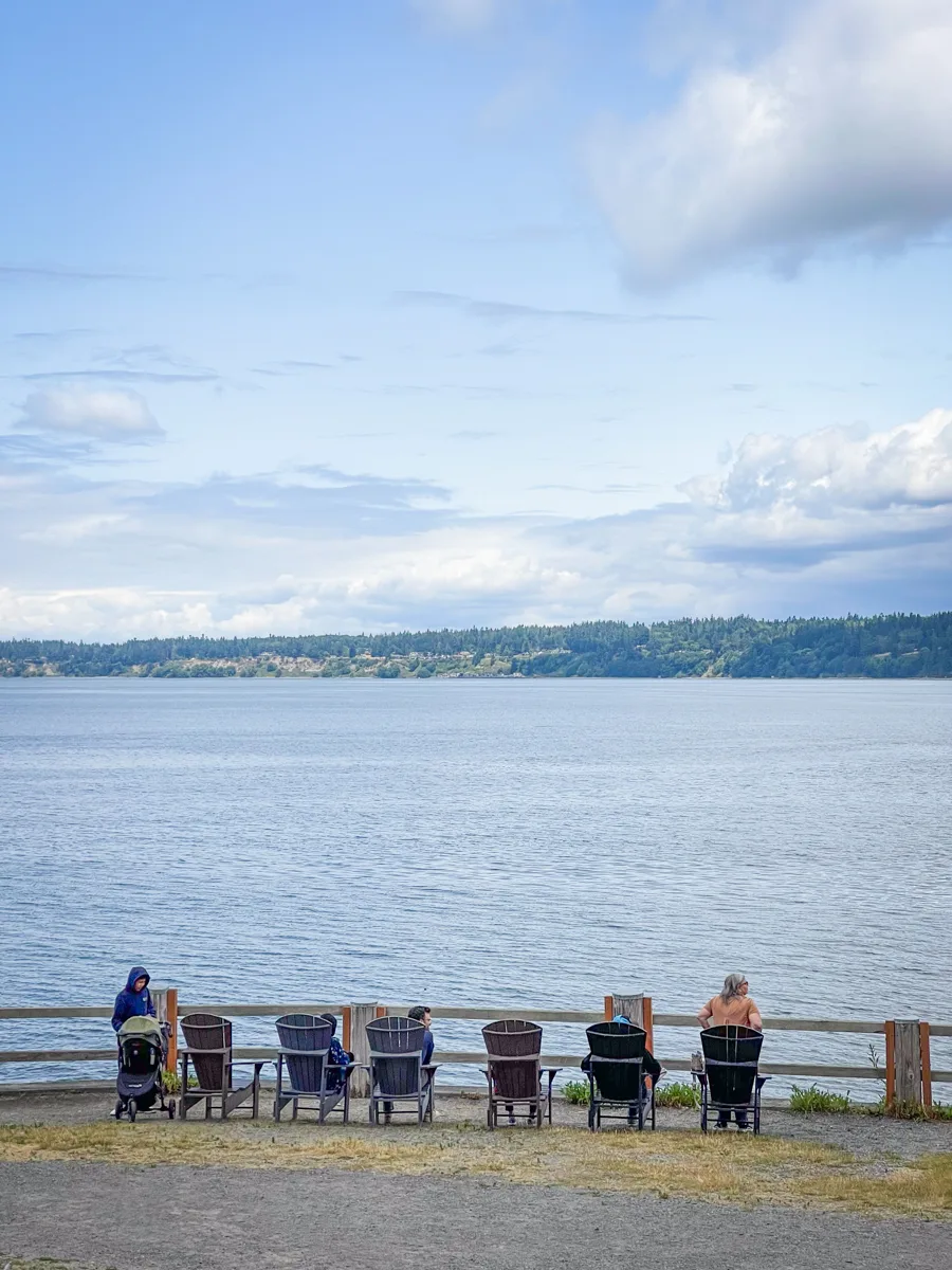 row of Adirondack chairs along the waterfront in langley, a town on Whidbey Island.