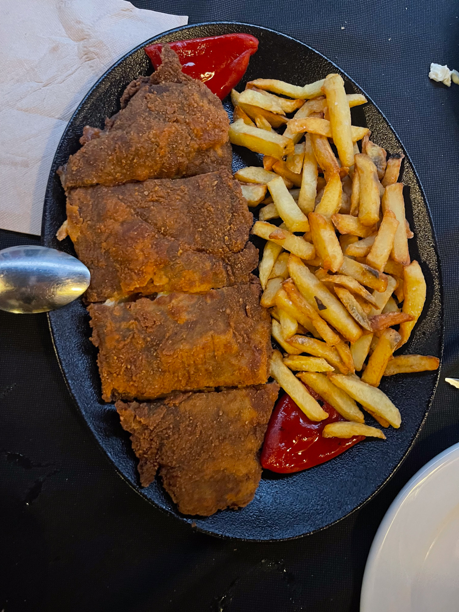 cachopo, a popular dish in asturias made with breaded veal stuffed with ham and cheese and served with fries on the side.